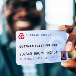 a man holds a Guttman Energy Fleet Fuel Card