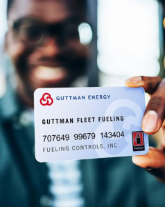 a man holds a Guttman Energy Fleet Fuel Card