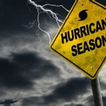 a hurricane season sign hangs in front of stormy clouds
