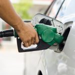 a person at a fuel pump filling up their car